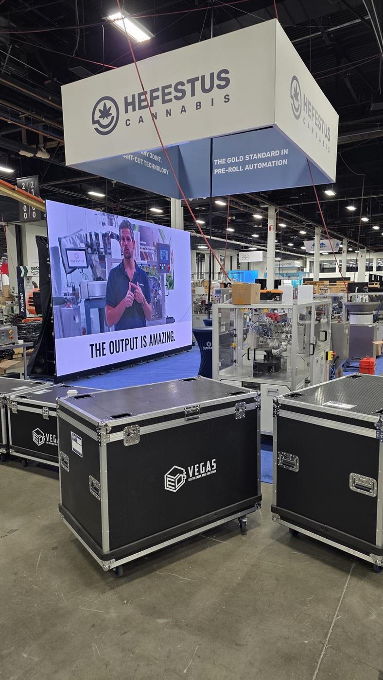 Trade show booth build in progress with LEDs VEGAS road cases beside the LED wall