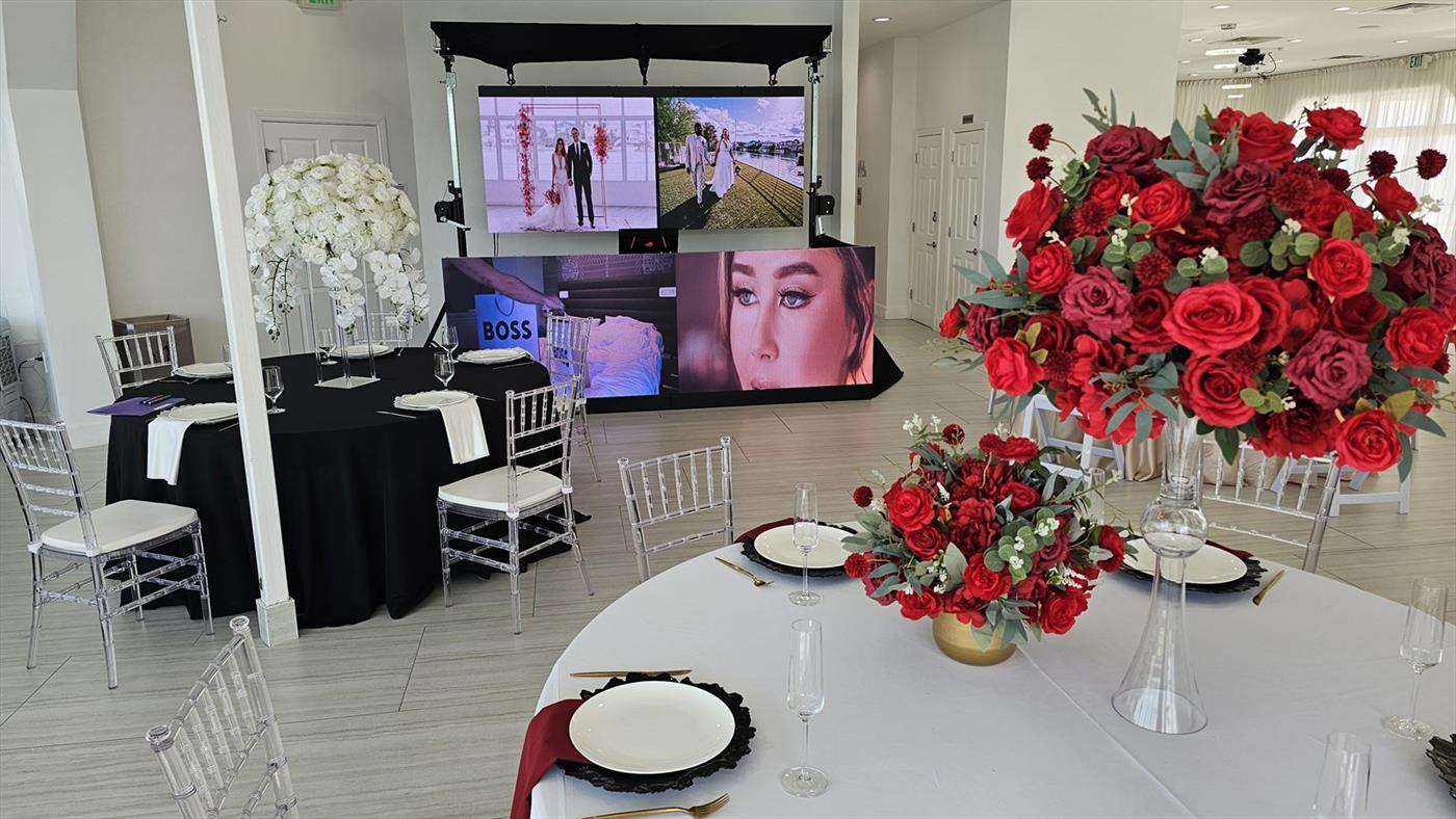 Two LED video walls at a wedding reception behind the head table